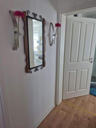 a mirror on a wall next to a door at Picco 2 in Beuren