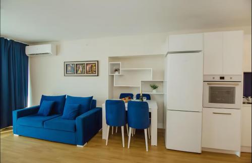 a living room with a blue couch and a table at Batumi black sea view central Hotel in Batumi