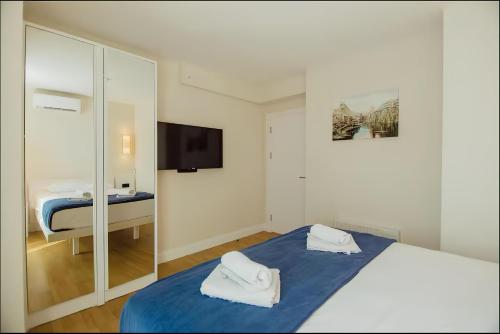 a hotel room with a bed and a mirror at Batumi black sea view central Hotel in Batumi
