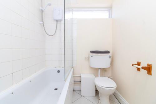 a white bathroom with a toilet and a shower at Brookvale Guest House Room 15 in Southampton