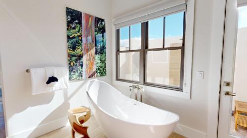 a white bathroom with a tub and a window at ❤PiH❤ Hale Moana Heated Private Pool Spa Detached Ohana Suite in Waimea