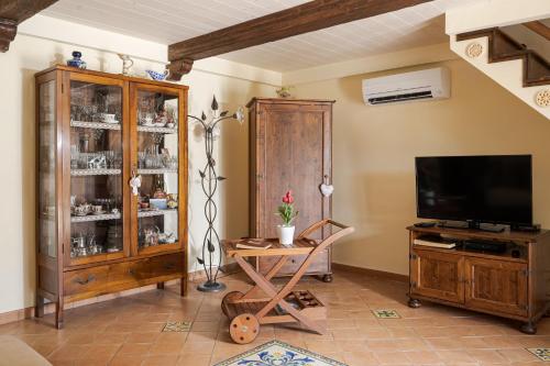 a living room with a tv and a entertainment center at Villa Mimì between Sorrento and Positano in Massa Lubrense