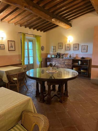 a living room with a table in a room at La Locanda Volpaia in Radda in Chianti