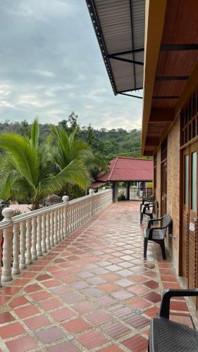 a balcony with benches on a building at Casa Campestre Villateresita in Anapoima