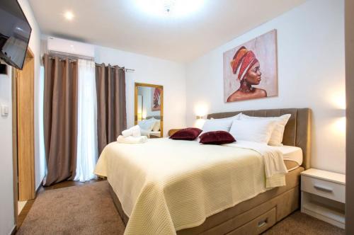 a bedroom with a large bed in a room at Lux rooms Split in Split