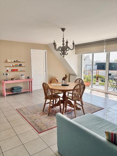 une salle à manger avec une table et des chaises dans l'établissement Golf et sentiers côtiers GR34, à Carantec