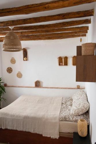 a bedroom with a white bed and wooden ceilings at Casa del Lago in Restábal