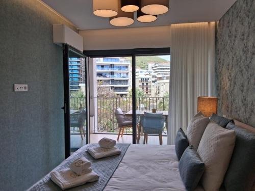 a bedroom with a bed with two towels on it at In-Town Residences in Funchal