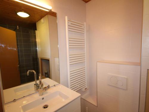 une salle de bain blanche avec un lavabo et un miroir dans l'établissement Appartement cosy 2 pièces cabine - Balcon sud, parking, pied des pistes - FR-1-293-122, à Hauteluce