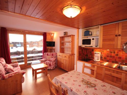 a kitchen and living room with a table in a room at Studio cabine lumineux avec balcon et vue, 4 pers, TV, Wi-Fi, Les Saisies - FR-1-293-142 in Les Saisies