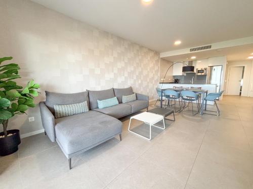 a living room with a couch and a table at Aqua Apartments Bellamar, Marbella in Marbella