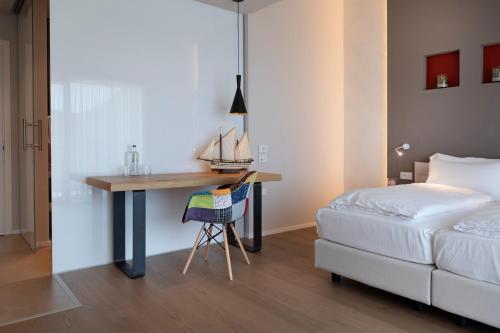 a bedroom with a desk next to a bed at Locanda Monte Baldo in Malcesine