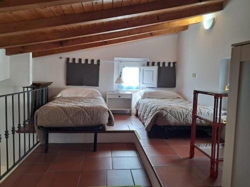 a bedroom with two beds and a window at Donna Lina in Matera