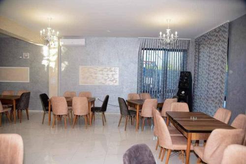 a dining room with tables and chairs in a room at Къща за гости Силвия in Shkorpilovtsi