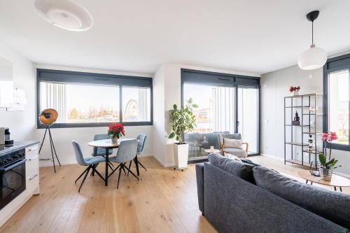 a living room with a couch and a table at Basel-Tram 8-Tristate-Bridge-Riverview in Huningue