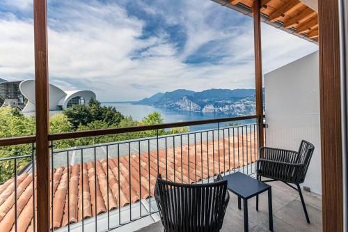 a balcony with two chairs and a view of the water at Locanda Monte Baldo in Malcesine