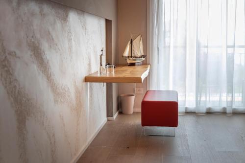 a room with a desk and a red stool at Locanda Monte Baldo in Malcesine
