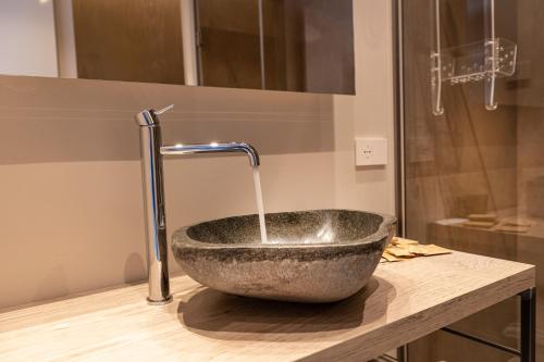 a bathroom with a stone sink with a faucet at Locanda Monte Baldo in Malcesine