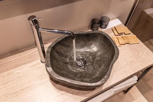 a stone sink on a table in a bathroom at Locanda Monte Baldo in Malcesine