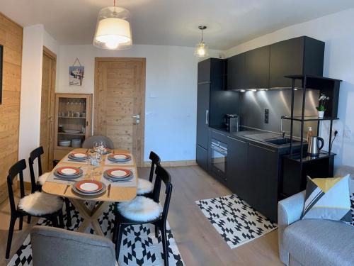 une cuisine et une salle à manger avec une table et des chaises dans l'établissement **Appartement de standing - 6 pers, 47m², 100m des pistes, Les Saisies** - FR-1-293-267, à Hauteluce