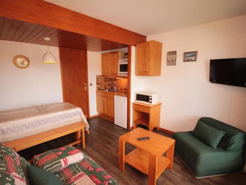 a small living room with a bed and a couch at Studio cabine Les Saisies, 4 pers, balcon sud, TV, proche pistes - FR-1-293-332 in Hauteluce