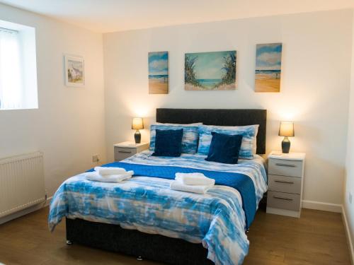 Un dormitorio con una cama grande con sábanas azules. en 2 Bed in TENBY FB284, en Tenby