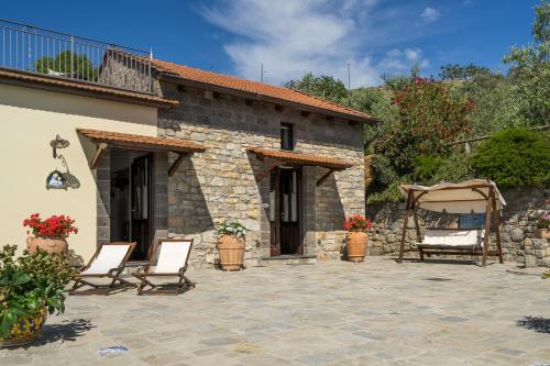a patio with two chairs and a building at Villa Mimì between Sorrento and Positano in Massa Lubrense