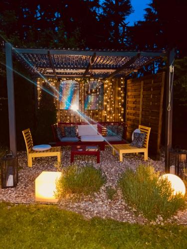a backyard patio with a pergola at night at Fortwilliam Farm T12DNN2 in Cork