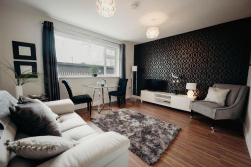 a living room with a white couch and a table at Hinckley Flats in Hinckley