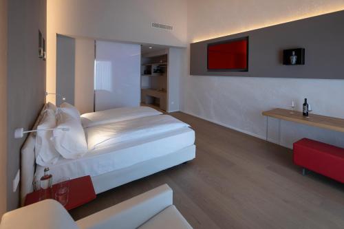 a bedroom with a white bed in a room at Locanda Monte Baldo in Malcesine