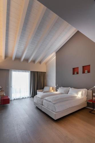 a large bedroom with a large bed and a large window at Locanda Monte Baldo in Malcesine