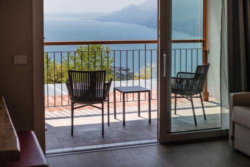two chairs and a table on a balcony at Locanda Monte Baldo in Malcesine