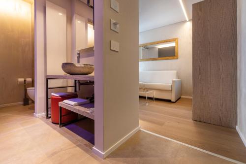 a hallway with a room with a sink and a bathroom at Locanda Monte Baldo in Malcesine