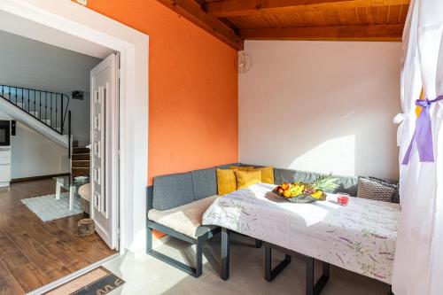 a dining room with a table and a couch at Melek in Štivan