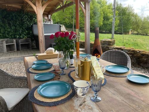 a wooden table with blue plates and flowers on it at Oak house in Rosedale Abbey