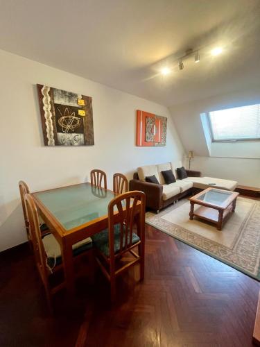 a living room with a table and a couch at As Marismas - Miño in Miño