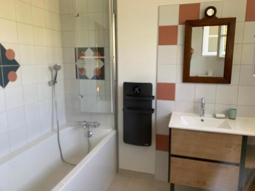 a bathroom with a tub and a sink and a shower at Longue Vue en Arbois in Arbois