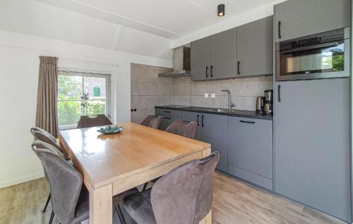 a kitchen with a wooden table and chairs in a kitchen at 3 Bedroom Gorgeous Home In Den Ham in Den Ham