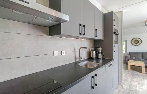 a kitchen with white cabinets and a sink at 3 Bedroom Gorgeous Home In Den Ham in Den Ham