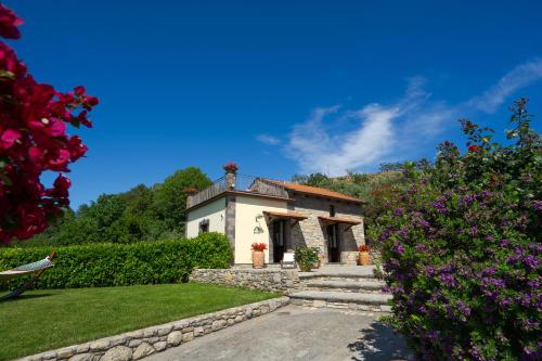 a house in a garden with purple flowers at Villa Mimì between Sorrento and Positano in Massa Lubrense