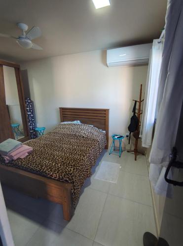 a bedroom with a leopard print bed in a room at Chalé da Márcia com Piscina e Churrasqueira Privativos in Buzios