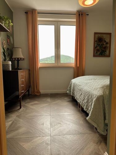 a bedroom with a bed and a window at Lawendowy Raj in Pilchowice