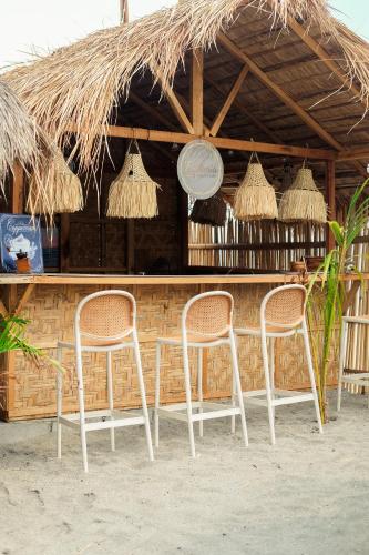 a couple of chairs sitting in front of a bar at Euphoria Zambales in Botolan