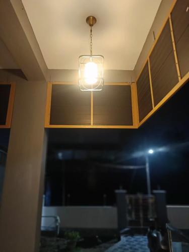 a light hanging from a ceiling in a room at Little Hearts in Chennai