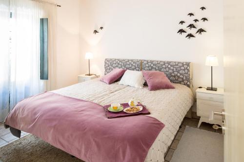 a bedroom with a bed with a tray of food on it at Casas de São José in Rio Maior