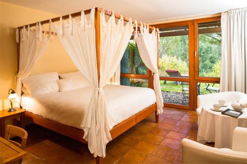 a bedroom with a bed with a canopy at Atrio in Estreito da Calheta
