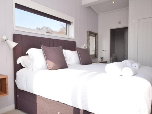 a bedroom with two large white beds with a window at 2 Bed in St Andrews 72435 in Anstruther