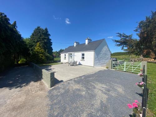 a driveway leading to a white house at Sage Cottage - Self Catering in Gort