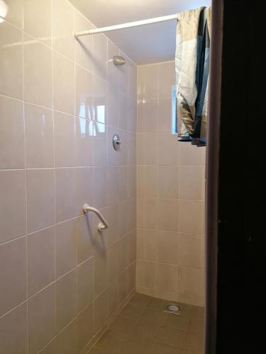 a bathroom with a shower with a glass door at Aille River Tourist Hostel Glamping Doolin in Doolin