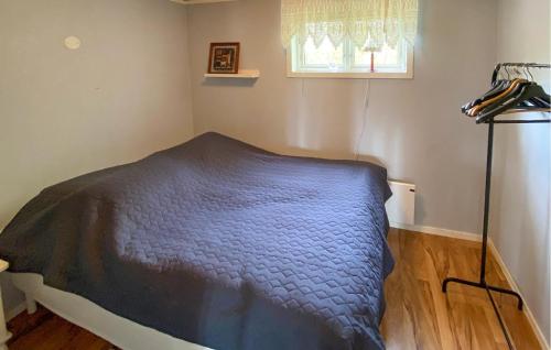 a bedroom with a blue bed in a room at 1 Bedroom Lovely Home In Ulseröd in Ulseröd